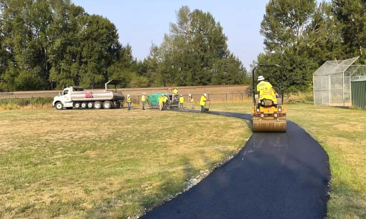 Crews put the finishing touches on the asphalt track at Columbia Elementary in Woodland. Granite Construction gave the Woodland Parent Teacher Student Association quite the discount in finishing the project. Photo courtesy Woodland PTSA