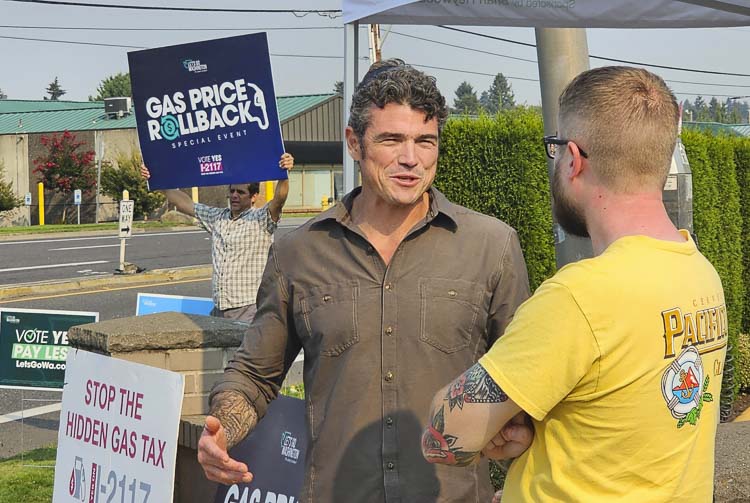 Joe Kent, the Republican nominee for Washington’s 3rd Congressional District, talks to Vancouver’s Kyle Anson at the Let’s Go Washington Gas Rollback Event in Vancouver on Friday. Photo by Paul Valencia