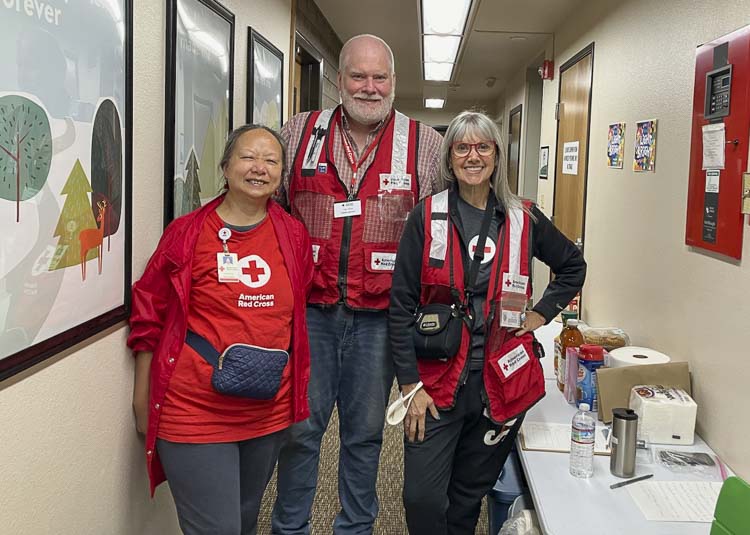 Susanna Pai, Toby Bates, and Barbara Anchia were among the Red Cross workers who helped displaced residents into a temporary shelter at the Ridgefield Church of the Nazarene this week. Photo courtesy Nora Mattingly