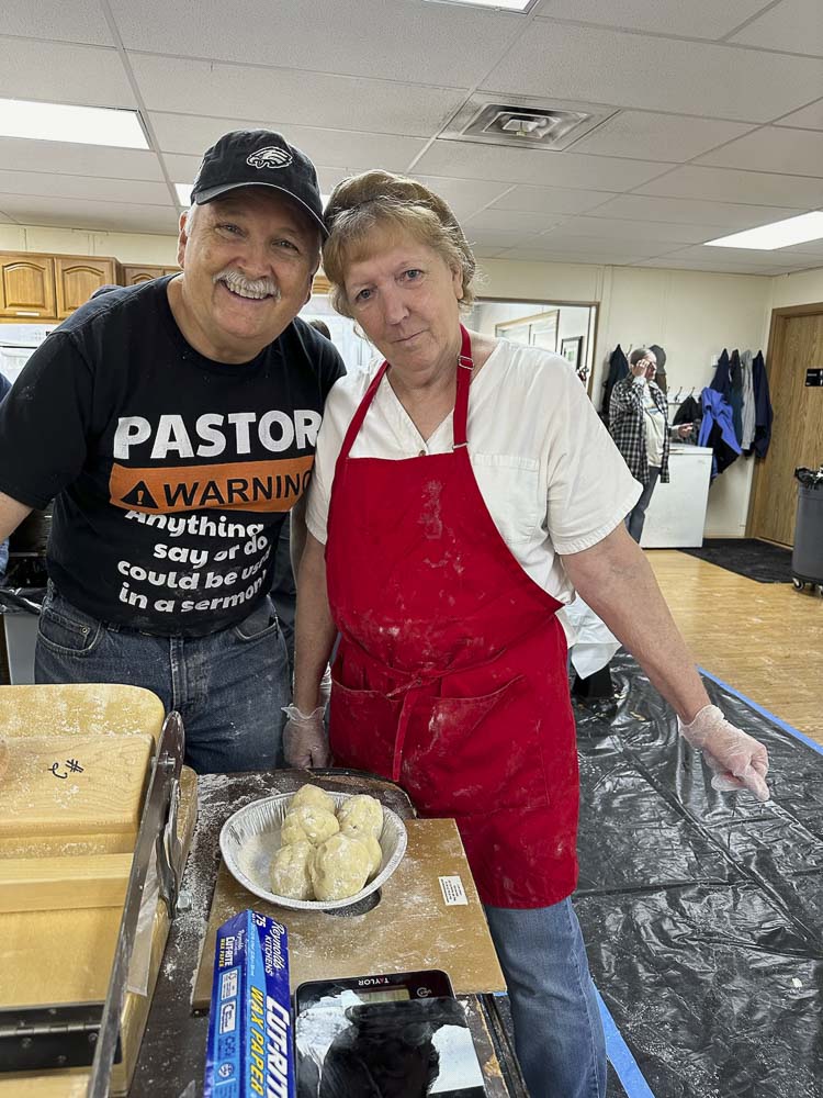 Merrill Caviness, pastor at Riverside Christian Church, and church member Cheri Bradford are all smiles after helping to make more than 1,100 apple dumplings. Riverside Christian School is hosting its annual Apple Festival on Sunday, Oct 13. Photo courtesy Riverside Christian School