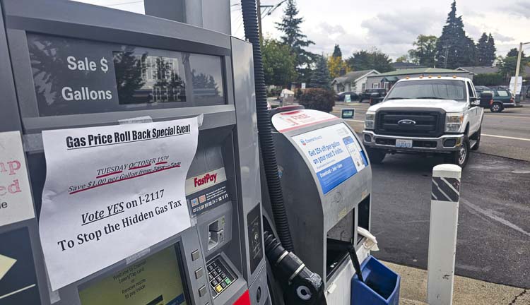 Signs were posted on pumps that there would be a gas price rollback event on Tuesday, and drivers showed up for the savings. Photo by Paul Valencia