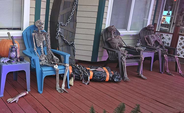 Here are a few skeletons on the porch, having a conversation. They are just part of the Silver Star Cemetery Halloween display. Photo by Paul Valencia