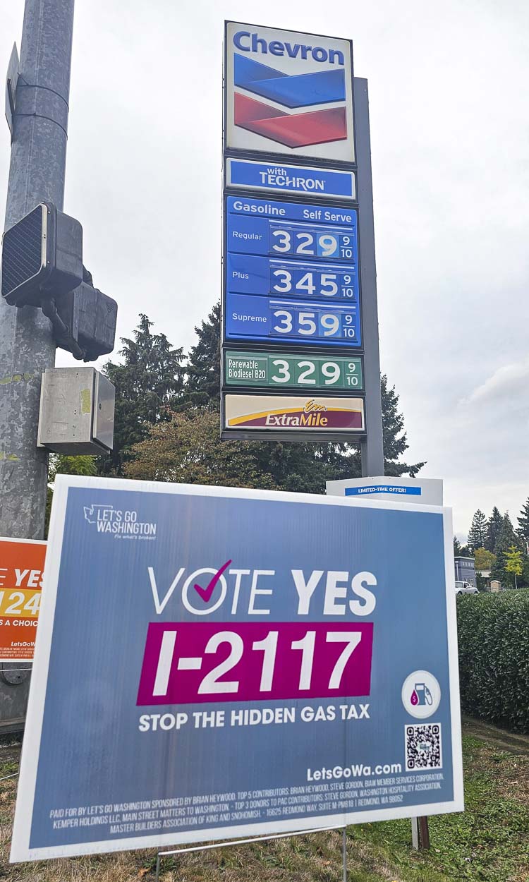 Let’s Go Washington rolled back gas prices $1 per gallon at this Chevron on Main Street and 39th Street for two hours on Tuesday to show drivers in Washington that they are paying too much in taxes. If Initiative 2117 passes, gas prices should decrease in Washington. Photo by Paul Valencia