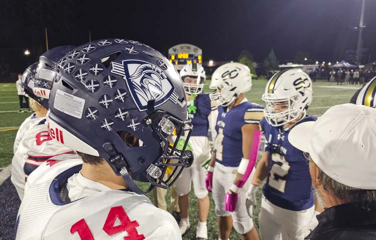 Captains from King’s Way Christian and Seton Catholic football meet at midfield for the coin toss Friday night. Photo by Paul Valencia