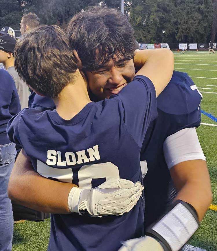 Skyview’s Chris Phillips, one of William “Liam” Sloan’s best friends, hugs Liam’s younger brother Aiden after Saturday’s emotional game. The Skyview Storm played in honor of Liam, who passed away unexpectedly earlier in the week. Photo by Paul Valencia