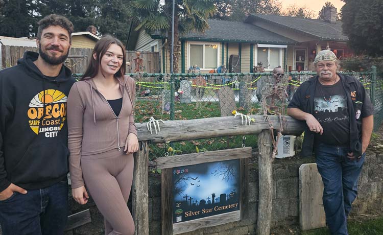 Eric Poteete, (right) was not sure his annual Halloween display would be put up this year due to a health scare. But his granddaughter, Savannah Keithley, and her husband Patrick, said the show must go on, and they helped put up the display this year. Photo by Paul Valencia