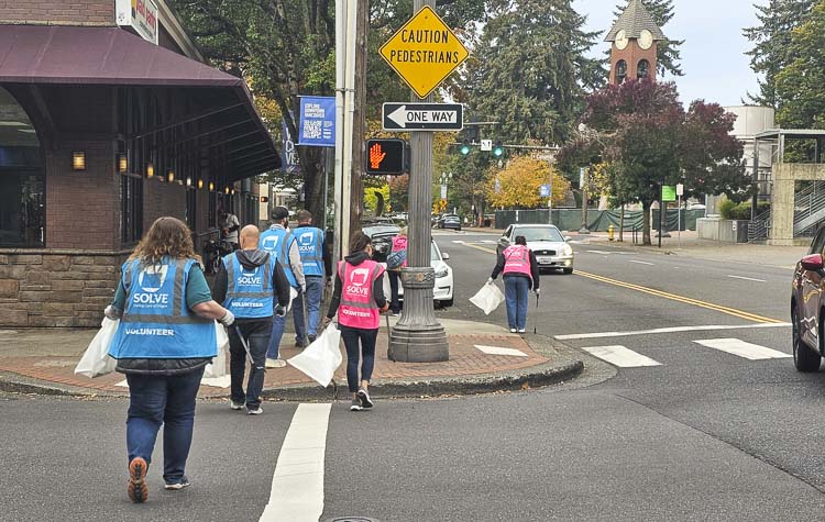 Reacher pick-up sticks, gloves, vests, and a good pair of shoes were essential as volunteers took two-hour shifts to pick up trash in downtown Vancouver on Friday morning. Photo by Paul Valencia