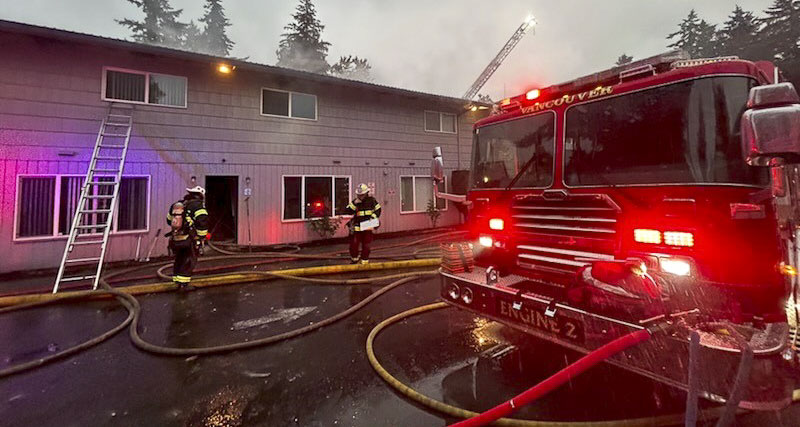 An apartment fire in Vancouver displaced seven people as firefighters battled flames through the roof of the building.