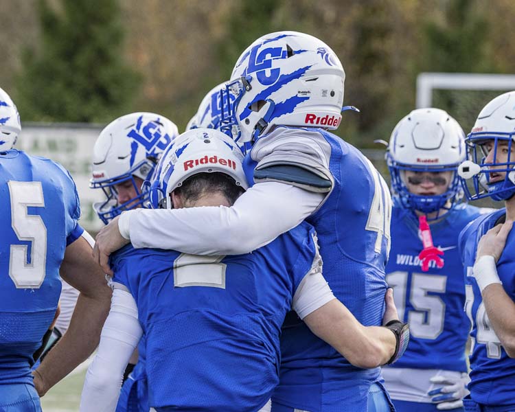 Gaven Emerson (2) and Zayne Latham (44) support each other after La Center’s playoff loss Saturday in the Class 1A state quarterfinals. Photo by Mike Schultz