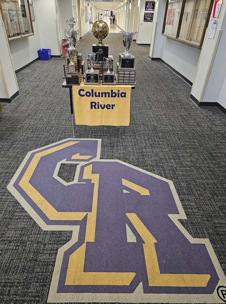 A bunch of trophies greet visitors at the main entrance at Columbia River High School. These are from fall sports teams at the school, including a state championship trophy in the middle for the volleyball squad. Photo by Paul Valencia