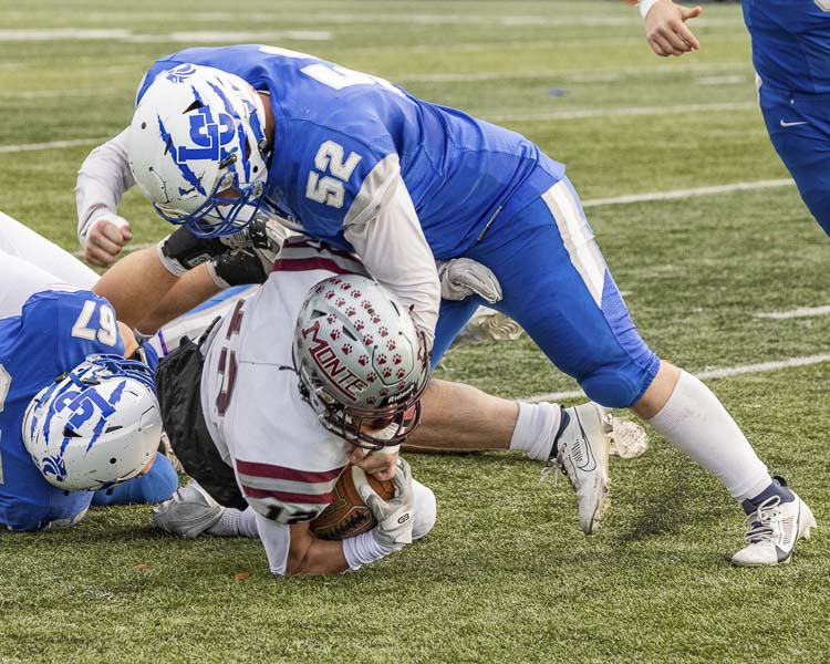 a Center senior Tyson Grove finishes off a tackle in Saturday’s state playoff game. Photo by Mike Schultz