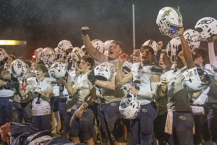 Seton Catholic football players celebrate their program’s first league championship Friday night after defeating La Center. Photo by Mike Schultz