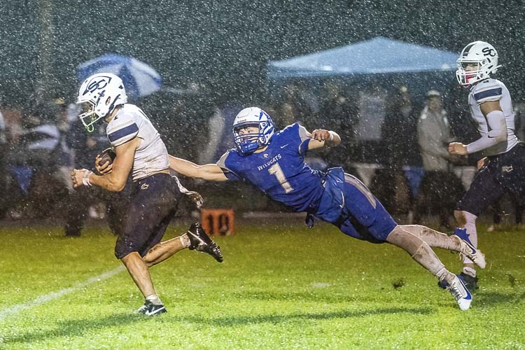 Seton Catholic’s Joe Callerame battles the La Center Wildcats and the weather, helping the Cougars to a Trico League championship. Photo by Mike Schultz