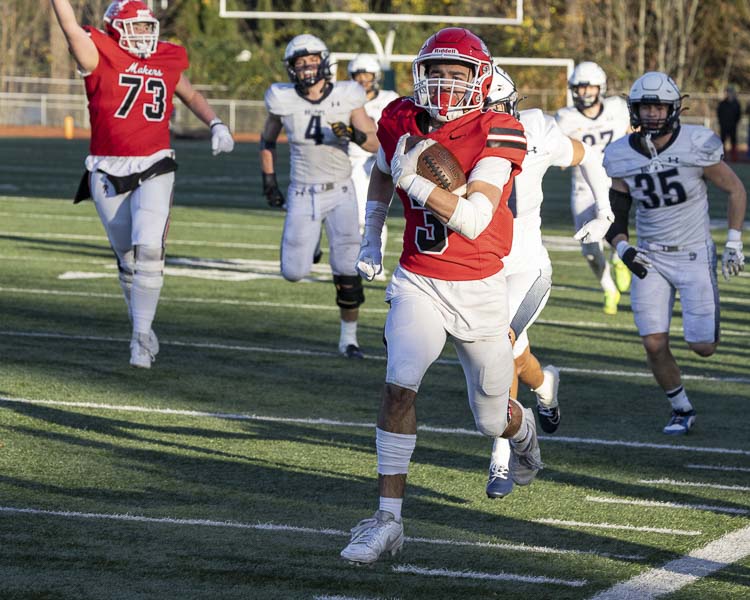 Anthony Forner takes off on a screen pass, while Ryan Criddle (73) celebrates the soon-to-be touchdown that gave Camas the lead in the fourth quarter Saturday. Photo by Mike Schultz