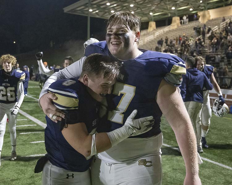 Garrett Nebels (8) and Austin St. Amour celebrate Seton Catholic’s historic victory in the state semifinals Saturday. Photo by Mike Schultz