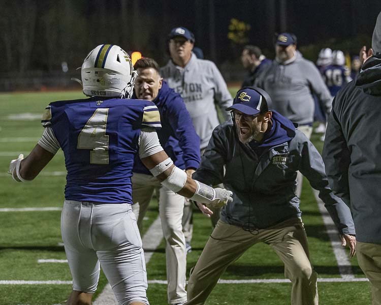 Seton Catholic coach Dan Chase celebrates a Jacob Williams (4) touchdown Saturday. Photo by Mike Schultz