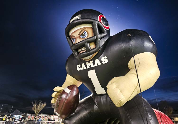 Kong, the inflatable Camas football player, rises high into the night sky before Camas’ playoff game at Doc Harris Stadium on Friday. Photo by Paul Valencia