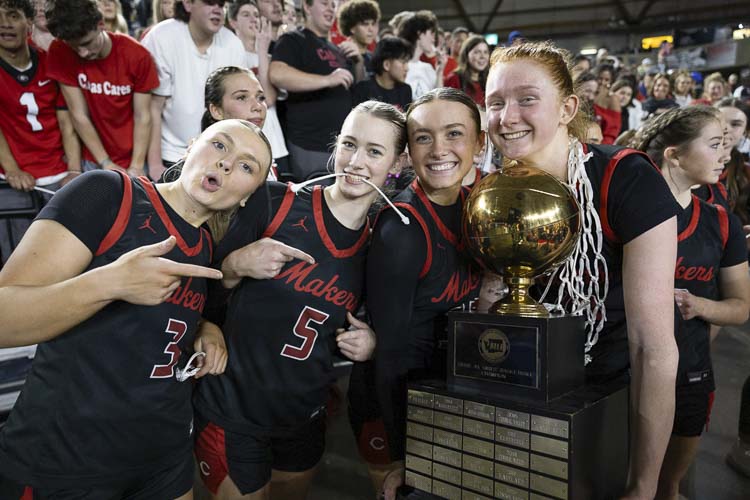 Camas Papermakers Riley Sanz, Parker Mairs, Keirra Thompson, and Addison Harris hang out with the state championship trophy back in March of 2024. Photo by Mike Schultz