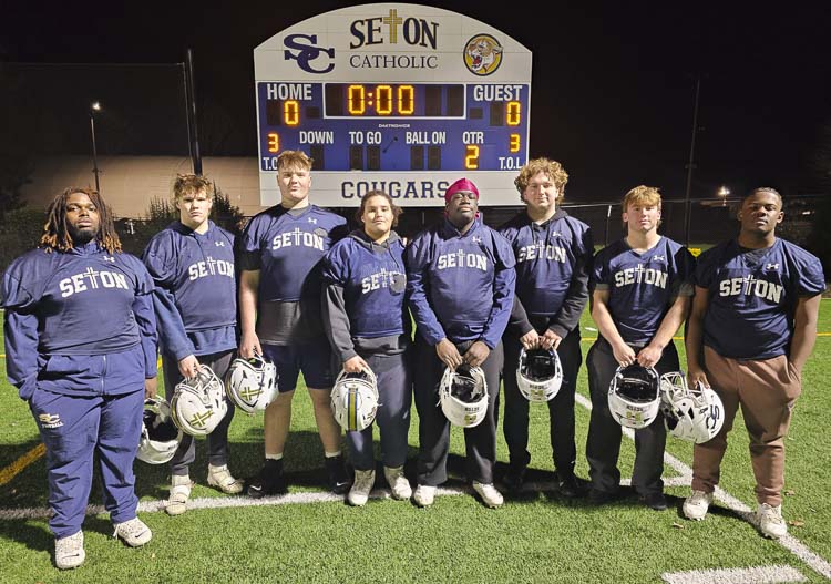 Ja’Marcus Robinson, wearing red on his head, is a two-way starter on the offensive and defensive lines for the Seton Catholic Cougars. His linemen teammates pictured here are, left to right: Houston Wells, A J Bradshaw, Austin St. Amour, Jessan Tillie, Alex Dayoob, Dylan Hamilton, and Jayden Henderson. Photo by Paul Valencia