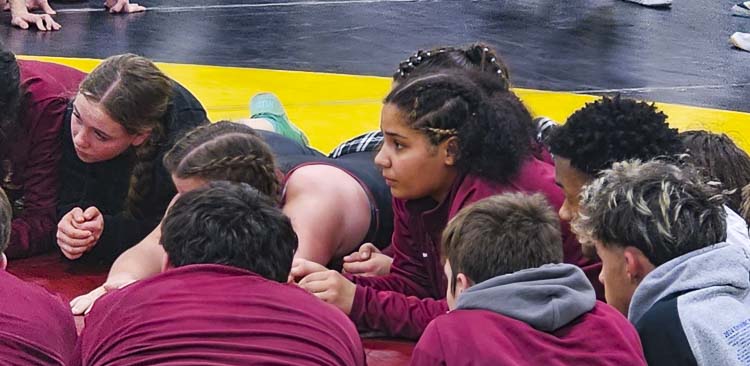 Prairie senior Faith Tarrant, focused here at a team meeting just prior to the start of the Pac Coast Wrestling Championships Friday, is also focused on winning a fourth consecutive state title this season. She is not taking that for granted, though. She said she has to stay humble and keep working hard. Photo by Paul Valencia