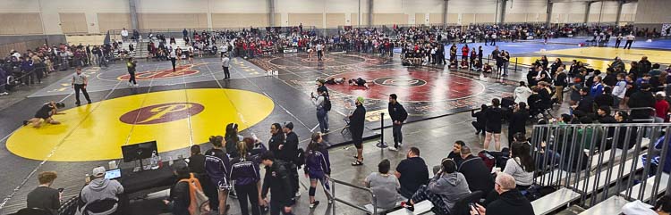 Early action of the Pac Coast Wrestling Championships on Friday morning at the Clark County Event Center in Ridgefield. There are more than 60 boys teams and 45 girls teams at this year’s wrestling extravaganza. Photo by Paul Valencia