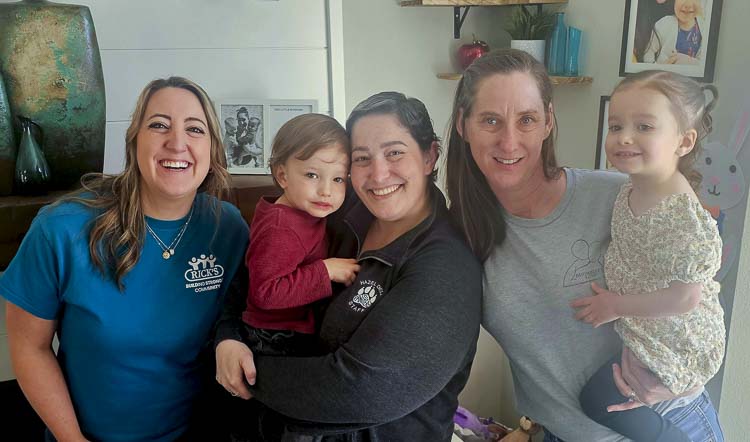 From left to right, Taylor Stanley, River, Kayla Susick, Andy Royal McCandless, and Marcella are all smiles Friday in Vancouver. Royal McCandless of Michelle’s Love and Stanley, representing Rick’s Custom Fencing and Decking, were at Kayla’s house as part of a home improvement project. Michelle’s Love helps single mothers who are undergoing cancer treatment. Kayla is the mom of twins Marcella and River. Photo by Paul Valencia