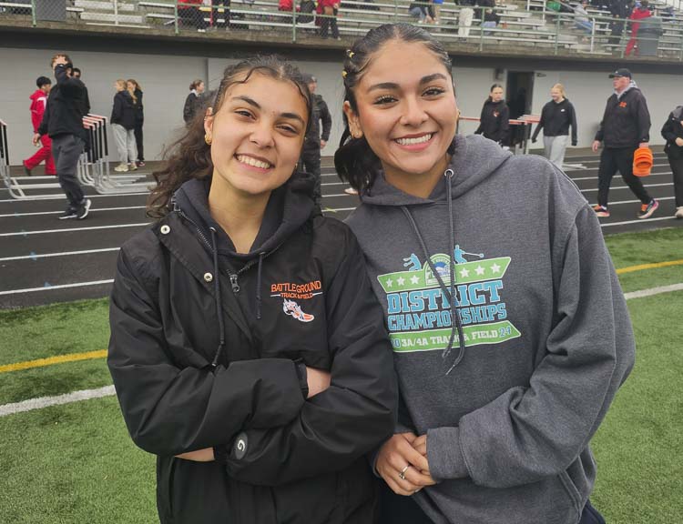Julia Stiffler, left, of Battle Ground, and Itzel Contreras Montiel of Prairie, are friends and competitors, enjoying the Tiger Invite on Saturday. Photo by Paul Valencia