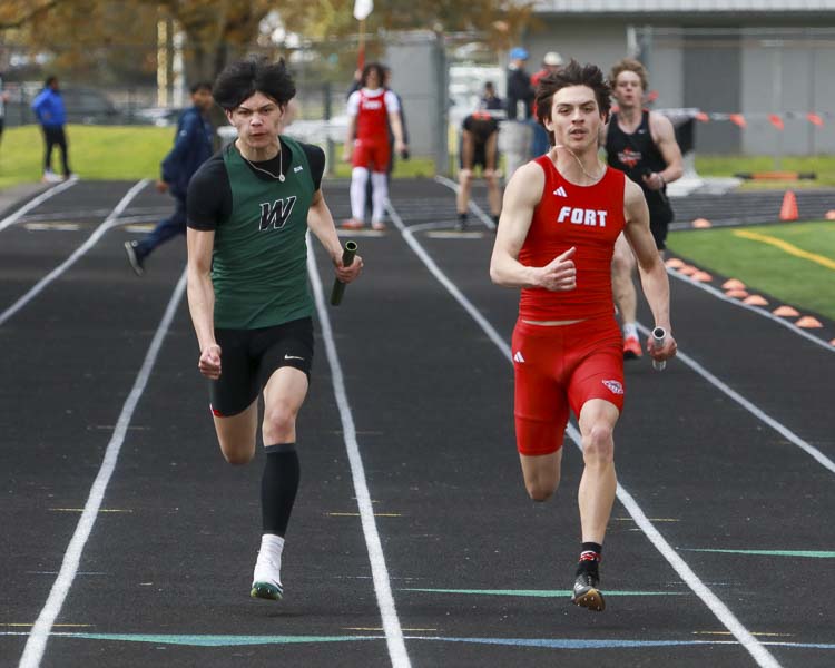Woodland’s Niel Valerio battles against Fort Vancouver’s Anthony Rivada in a heat of the 4x100 relay Saturday at the Tiger Invite. Photo courtesy Chris Barker